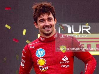 Charles Leclerc of Ferrari celebrates on the podium after winning the Italian Formula One Grand Prix at Autodromo Nazionale Monza circuit, i...