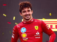 Charles Leclerc of Ferrari celebrates on the podium after winning the Italian Formula One Grand Prix at Autodromo Nazionale Monza circuit, i...