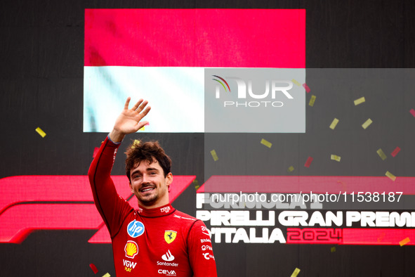 Charles Leclerc of Ferrari celebrates on the podium after winning the Italian Formula One Grand Prix at Autodromo Nazionale Monza circuit, i...