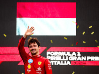 Charles Leclerc of Ferrari celebrates on the podium after winning the Italian Formula One Grand Prix at Autodromo Nazionale Monza circuit, i...