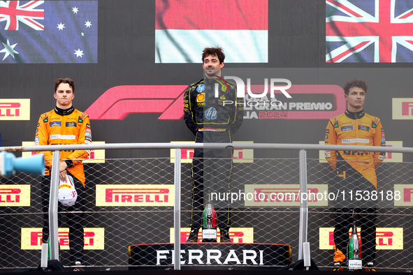 Charles Leclerc of Ferrari, Oscar Piastri of McLaren and Lando Norris of McLaren are seen on the podium after winning the Italian Formula On...