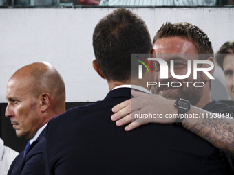 Juventus coach Thiago Motta hugs Roma coach Daniele De Rossi during the Serie A football match number 3 between Juventus and Roma in Turin,...