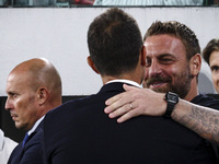 Juventus coach Thiago Motta hugs Roma coach Daniele De Rossi during the Serie A football match number 3 between Juventus and Roma in Turin,...