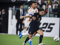 Juventus midfielder Nicolo Fagioli (21) fights for the ball against Roma midfielder Lorenzo Pellegrini (7) during the Serie A football match...