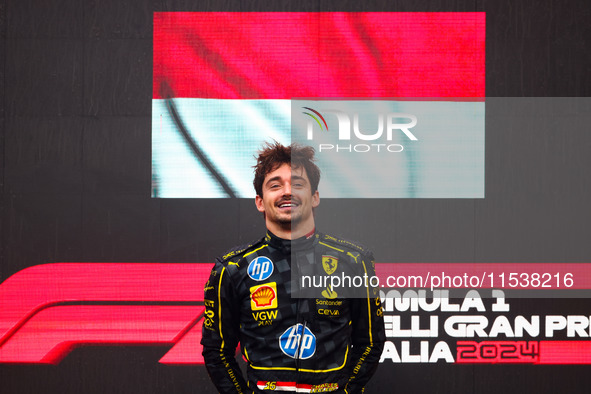 Charles Leclerc of Ferrari celebrates on the podium after winning the Italian Formula One Grand Prix at Autodromo Nazionale Monza circuit, i...