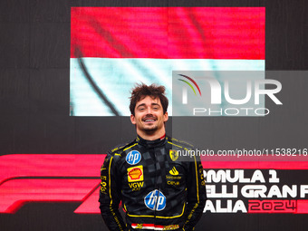 Charles Leclerc of Ferrari celebrates on the podium after winning the Italian Formula One Grand Prix at Autodromo Nazionale Monza circuit, i...