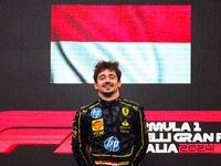 Charles Leclerc of Ferrari celebrates on the podium after winning the Italian Formula One Grand Prix at Autodromo Nazionale Monza circuit, i...