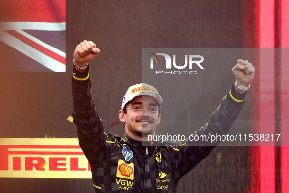 Charles Leclerc of Ferrari celebrates on the podium after winning the Italian Formula One Grand Prix at Autodromo Nazionale Monza circuit, i...