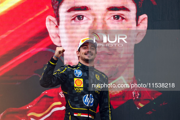 Charles Leclerc of Ferrari celebrates on the podium after winning the Italian Formula One Grand Prix at Autodromo Nazionale Monza circuit, i...