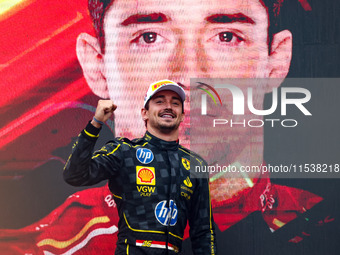 Charles Leclerc of Ferrari celebrates on the podium after winning the Italian Formula One Grand Prix at Autodromo Nazionale Monza circuit, i...