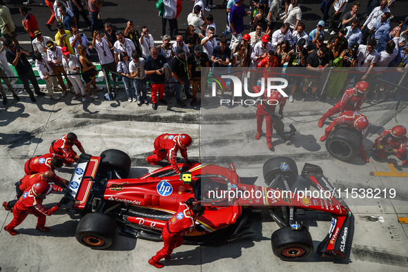 A car of Carlos Sainz of Ferrari is seen in front of a garage ahead of the Italian Formula One Grand Prix at Autodromo Nazionale Monza circu...