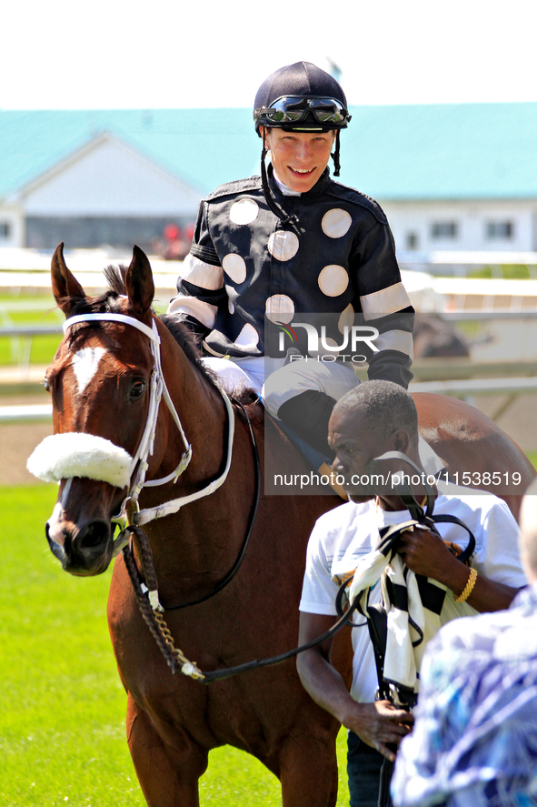 Jockey Emma-Jayne Wilson rides Ask in My Name to the winner's circle after a win in the second race at Woodbine Racetrack in Toronto, Canada...