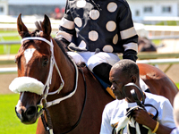 Jockey Emma-Jayne Wilson rides Ask in My Name to the winner's circle after a win in the second race at Woodbine Racetrack in Toronto, Canada...