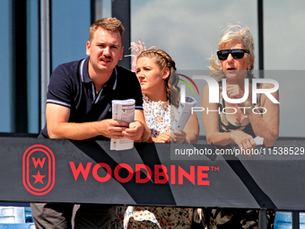 Race fans watch racing at Woodbine Racetrack in Toronto, Canada, on September 1, 2024. (