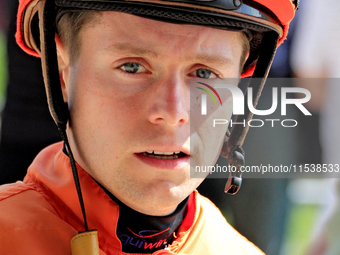 Jockey Austin Adams speaks with connections following the fifth race at Woodbine Racetrack in Toronto, Canada, on September 1, 2024. (