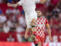 Isaac Romero of Sevilla FC battles for the ball during the La Liga EA Sports match between Sevilla FC and Girona CF at Nuevo Mirandilla in S...