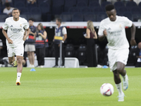 Vinicius Jr. of Real Madrid and Kylian Mbappe of Real Madrid warm up during the La Liga 2024/25 match between Real Madrid and Real Betis at...