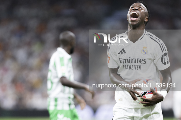 Vinicius Jr of Real Madrid reacts to a missed opportunity during the La Liga 2024/25 match between Real Madrid and Real Betis at Santiago Be...