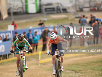 Puck Pieterse of the Netherlands and Candice Lill of South Africa participate in the UCI Mountain Bike World Championships Women in Pal Arin...