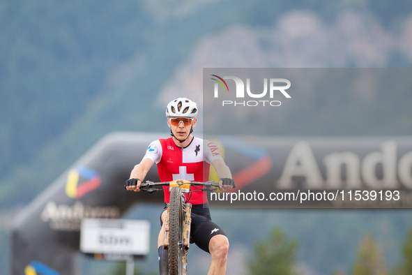 Dario Lillo of Switzerland crosses the finish line in the UCI Mountain Bike World Championships Men Under 23 Race in Pal Arinsal, Andorra, o...