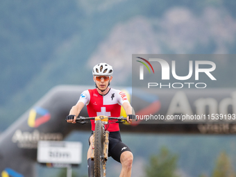 Dario Lillo of Switzerland crosses the finish line in the UCI Mountain Bike World Championships Men Under 23 Race in Pal Arinsal, Andorra, o...