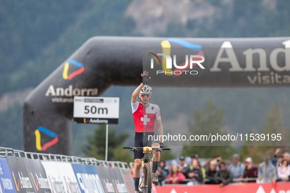 Dario Lillo of Switzerland crosses the finish line in the UCI Mountain Bike World Championships Men Under 23 Race in Pal Arinsal, Andorra, o...