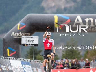 Dario Lillo of Switzerland crosses the finish line in the UCI Mountain Bike World Championships Men Under 23 Race in Pal Arinsal, Andorra, o...