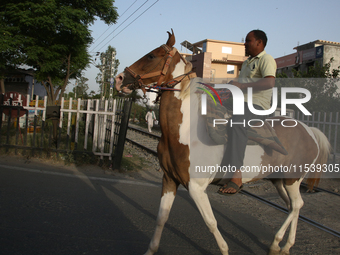 A man rides a horse in Bazpur, Uttarakhand, India, on April 19, 2024. (