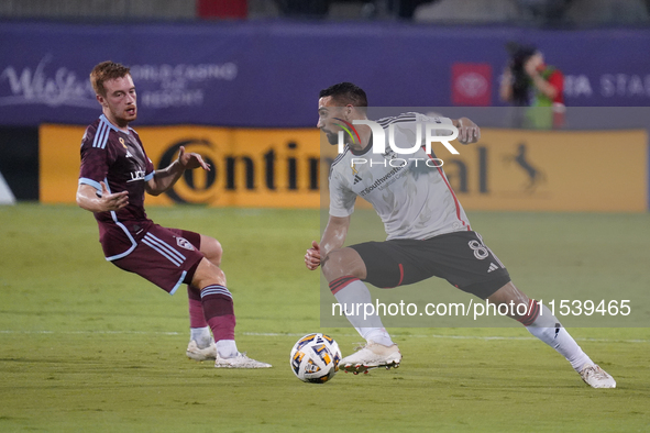 FC Dallas forward Sebastian Lletget #8 drives the ball against Connor Ronan #20 of Colorado Rapids during the MLS match between FC Dallas an...