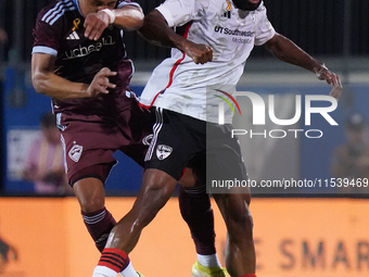 Colorado Rapids midfielder Jackson Travis #99 and FC Dallas midfielder Ruan Gregorio Teixeira #5 head for the ball during the MLS match betw...