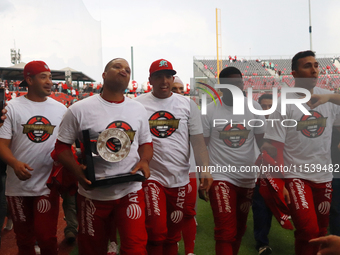 Robinson Cano #22 of Diablos Rojos holds the trophy after winning the South Zone 2024 championship series of the Mexican Baseball League (LM...