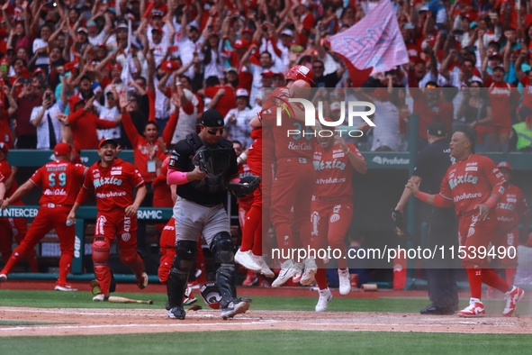 Diablos Rojos players celebrate at the end of match 7 of the Mexican Baseball League (LMB) South Zone 2024 championship series against Guerr...