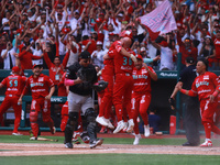 Diablos Rojos players celebrate at the end of match 7 of the Mexican Baseball League (LMB) South Zone 2024 championship series against Guerr...