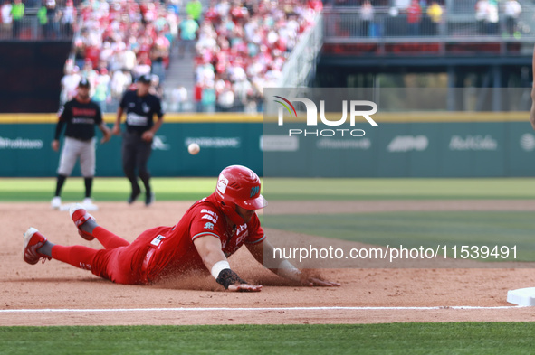 Ramon Flores #23 of Diablos Rojos slides to the third base plate during match 7 of the Mexican Baseball League (LMB) South Zone 2024 champio...