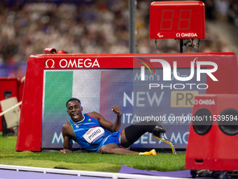 Maxcel Amo Manu of Italy reacts after he wins the Men's 100m - T64 Round 1 - Heat 2 with a personal best at Stade de France during the Paris...