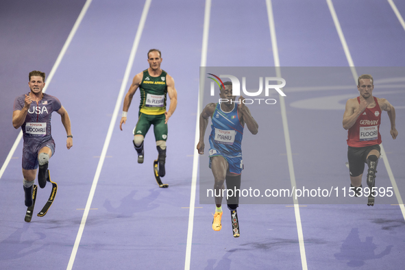 From left, Woodall of the USA, De Plessis of South Africa, Maxcel Amo Manu of Italy, and Floors of Germany compete during the Men's 100m - T...