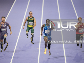 From left, Woodall of the USA, De Plessis of South Africa, Maxcel Amo Manu of Italy, and Floors of Germany compete during the Men's 100m - T...