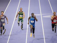 From left, Woodall of the USA, De Plessis of South Africa, Maxcel Amo Manu of Italy, and Floors of Germany compete during the Men's 100m - T...