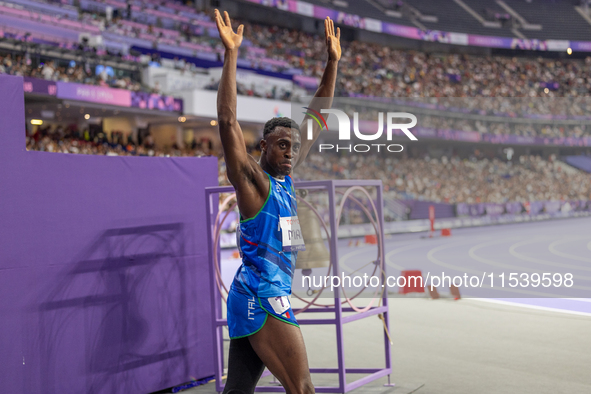 Maxcel Amo Manu of Italy reacts after he wins the Men's 100m - T64 Round 1 - Heat 2 with a personal best at Stade de France during the Paris...