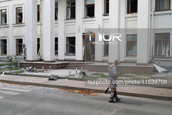 A man sweeps away debris near a building on Beresteiskyi Avenue damaged by a Russian missile attack in Kyiv, Ukraine, on September 2, 2024....