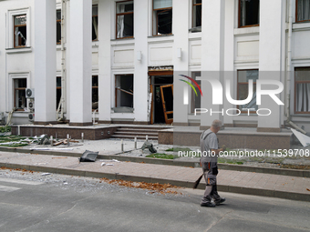 A man sweeps away debris near a building on Beresteiskyi Avenue damaged by a Russian missile attack in Kyiv, Ukraine, on September 2, 2024....