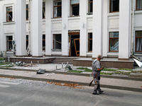 A man sweeps away debris near a building on Beresteiskyi Avenue damaged by a Russian missile attack in Kyiv, Ukraine, on September 2, 2024....