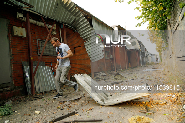 A man walks through the rubble at a building in the Sviatoshynskyi district damaged by the Russian missile attack in Kyiv, Ukraine, on Septe...