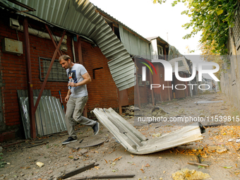 A man walks through the rubble at a building in the Sviatoshynskyi district damaged by the Russian missile attack in Kyiv, Ukraine, on Septe...