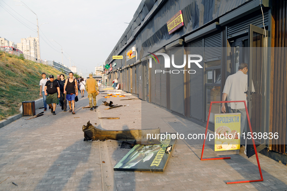 People walk past shops in the Sviatoshynskyi district damaged by the Russian missile attack in Kyiv, Ukraine, on September 2, 2024. NO USE R...