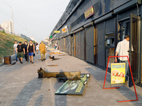 People walk past shops in the Sviatoshynskyi district damaged by the Russian missile attack in Kyiv, Ukraine, on September 2, 2024. NO USE R...