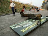 People walk past shops in the Sviatoshynskyi district damaged by the Russian missile attack in Kyiv, Ukraine, on September 2, 2024. NO USE R...