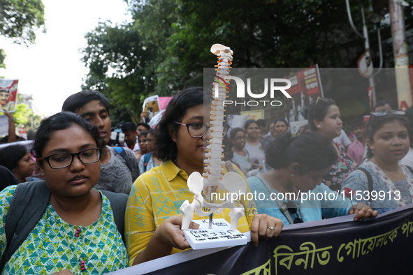 Medical students and doctors shout slogans during a protest rally towards Kolkata Police Headquarters, Lalbazar, protesting against the rape...