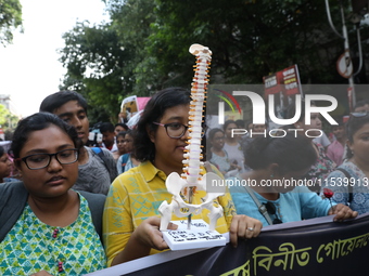 Medical students and doctors shout slogans during a protest rally towards Kolkata Police Headquarters, Lalbazar, protesting against the rape...