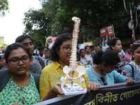 Medical students and doctors shout slogans during a protest rally towards Kolkata Police Headquarters, Lalbazar, protesting against the rape...